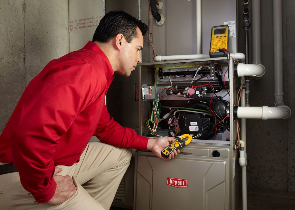 Heating technician diagnosing a furnace repair in Costa Mesa