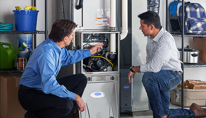 Technician evaluating a furnace for repair or replacement in Costa Mesa