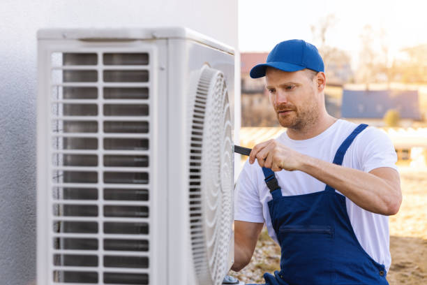 HVAC technician servicing an outdoor air conditioner in Costa Mesa