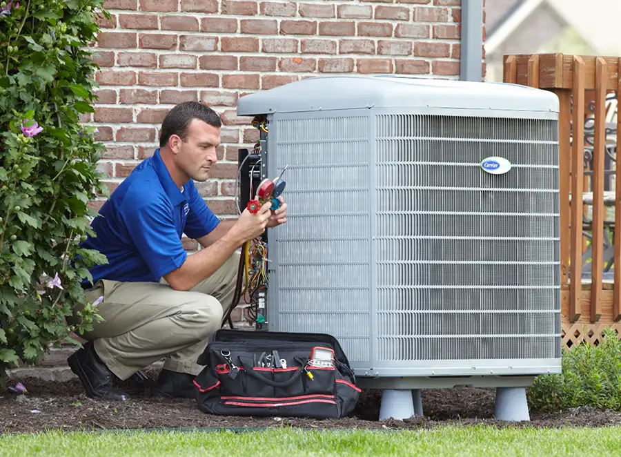 HVAC technician inspecting an outdoor AC unit in Costa Mesa