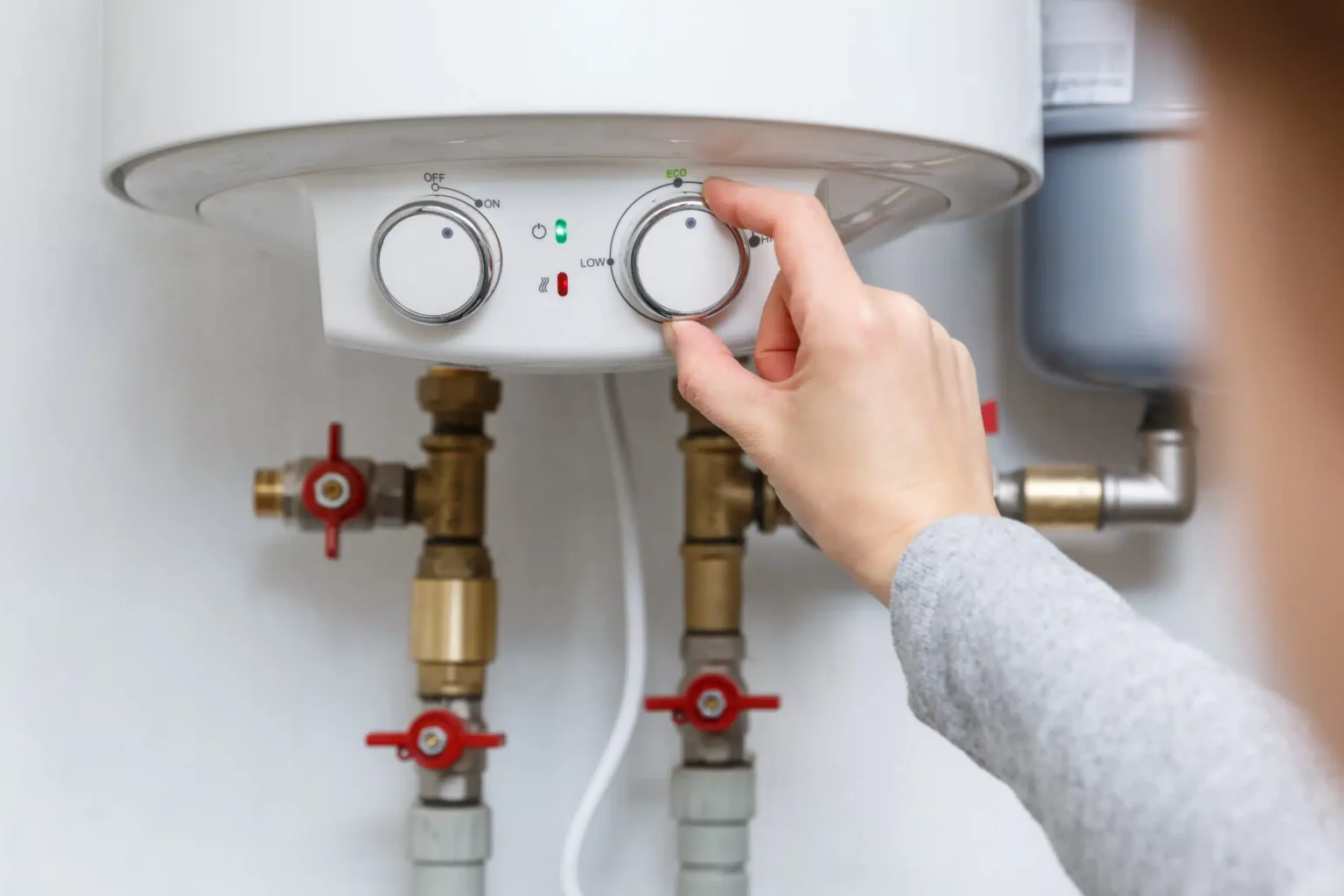 Technician adjusting a water heater in Costa Mesa